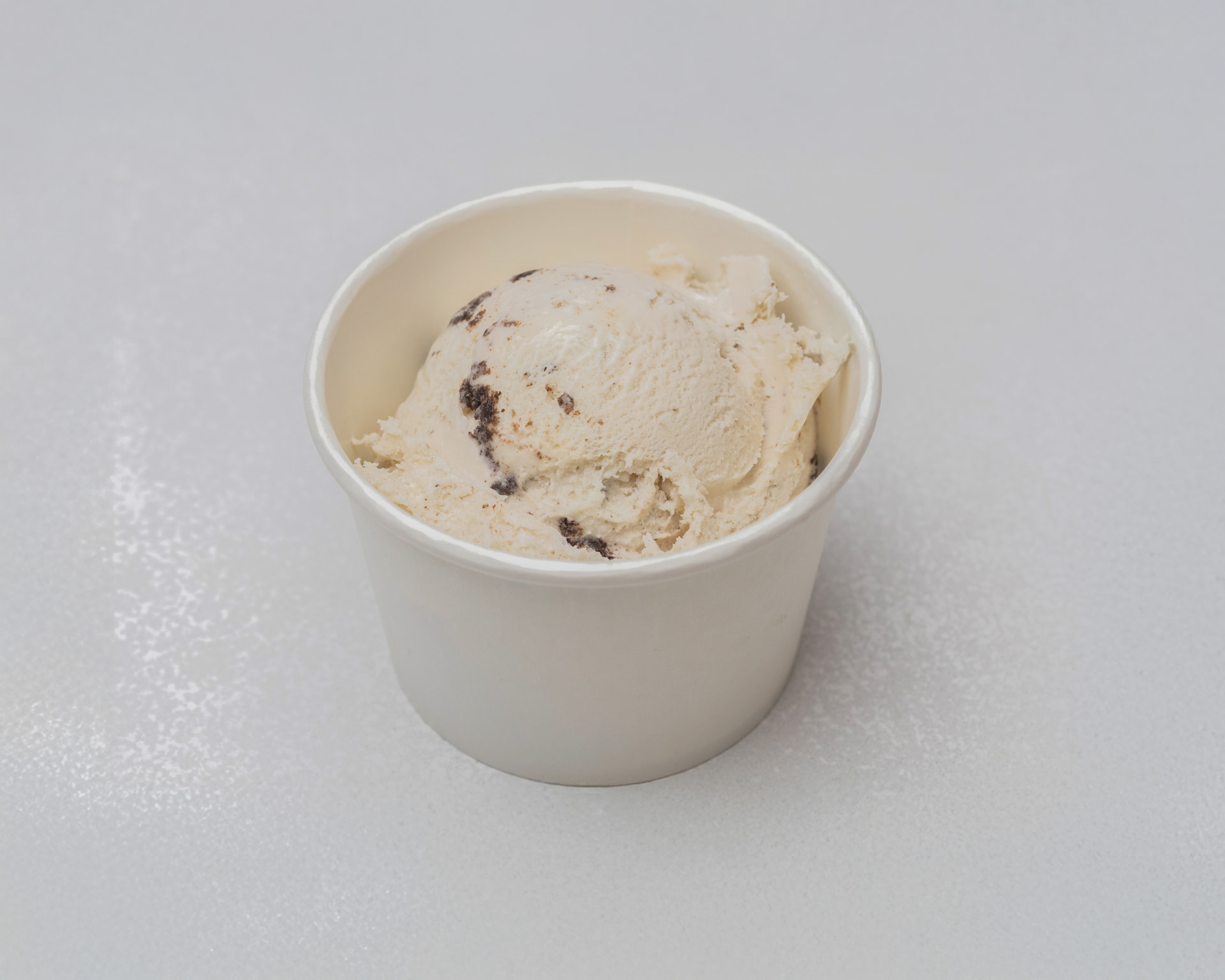 Cookies and cream ice cream in a white cup