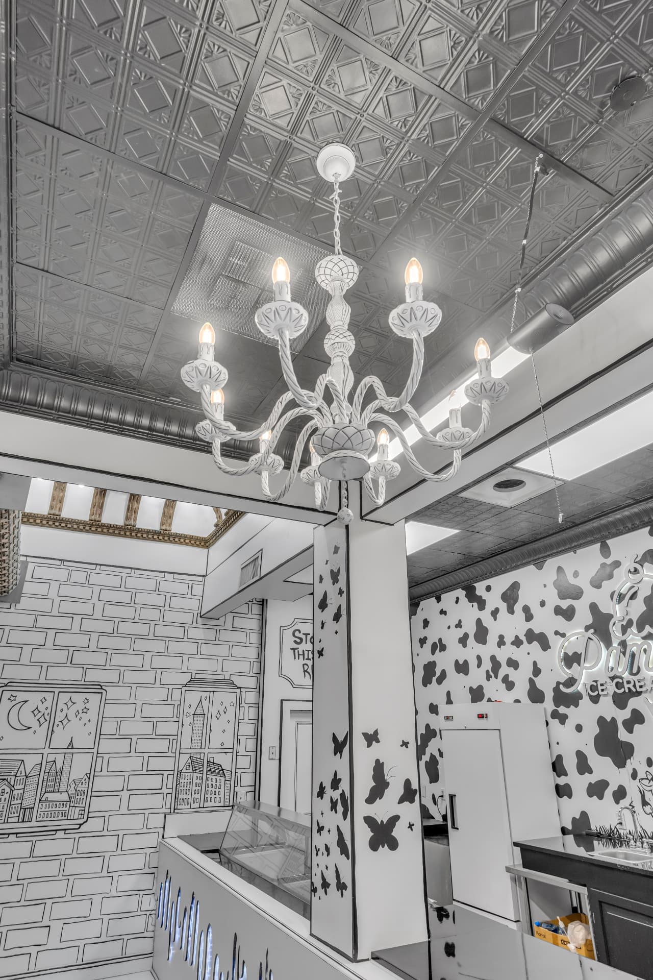 White chandelier under the Arcade's pressed tin ceiling inside Pammy's