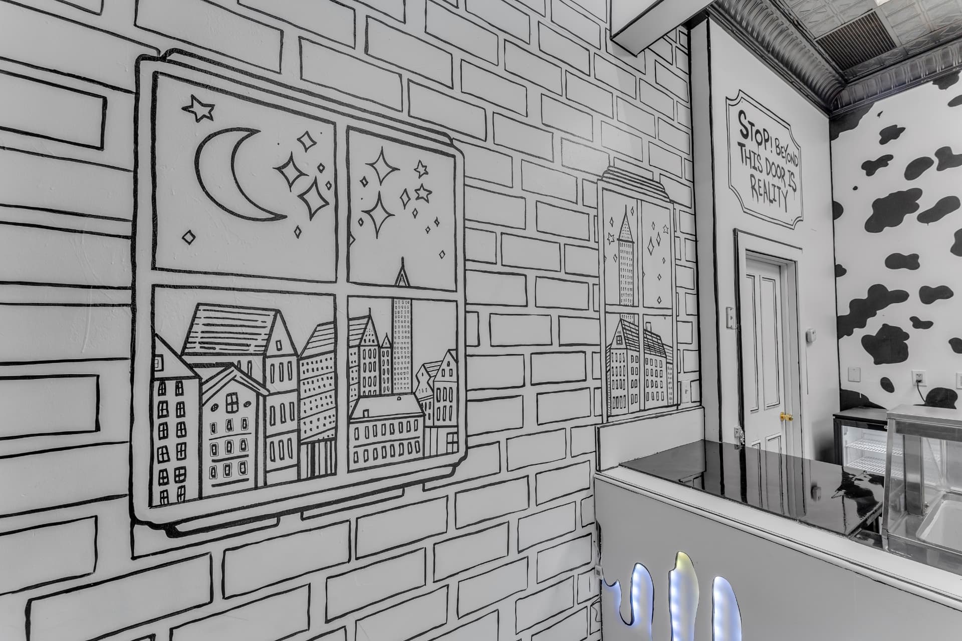 Drawn brick wall mural with Cleveland buildings and butterflies