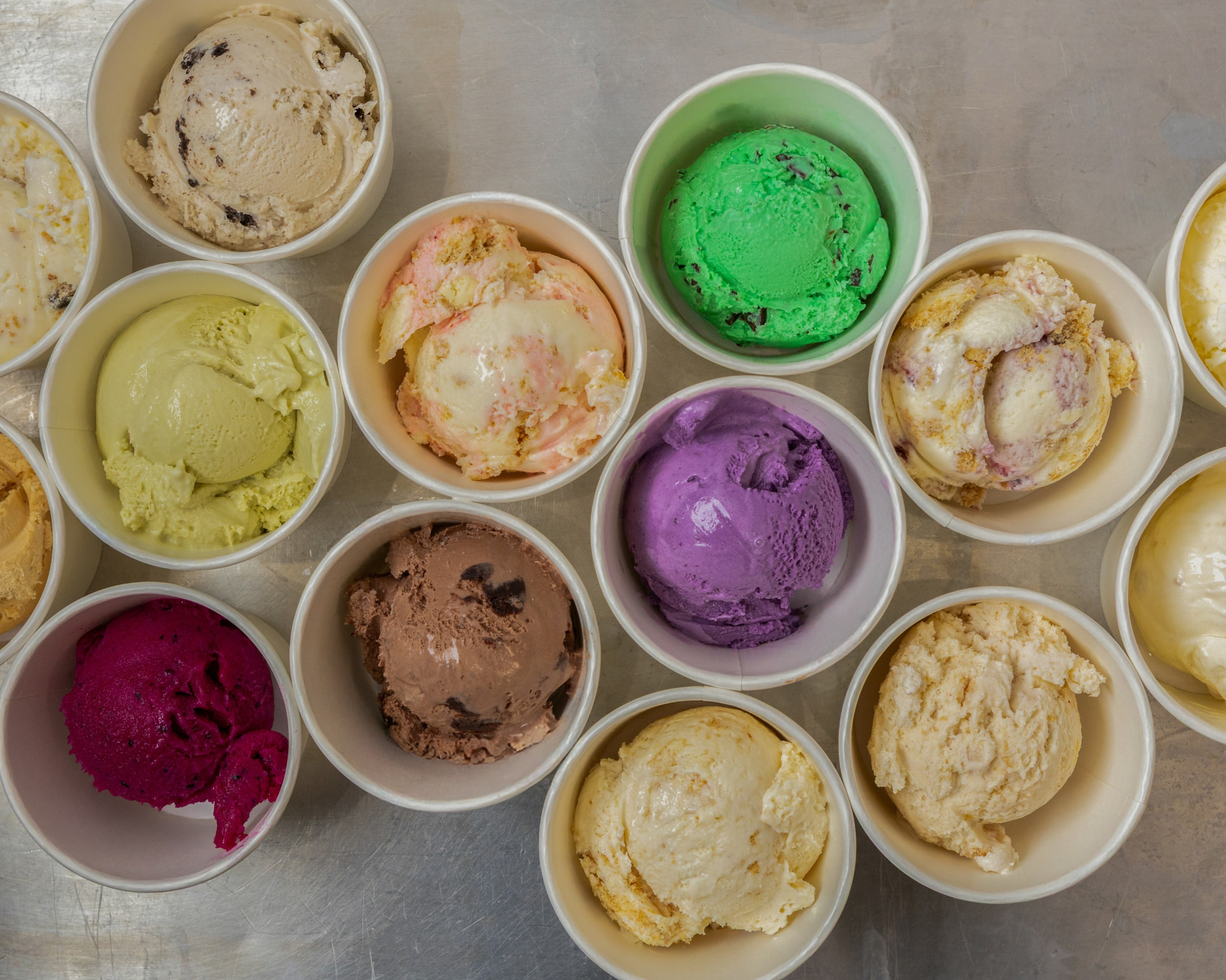 Overhead spread of colorful small-batch ice cream cups at Pammy's Ice Cream