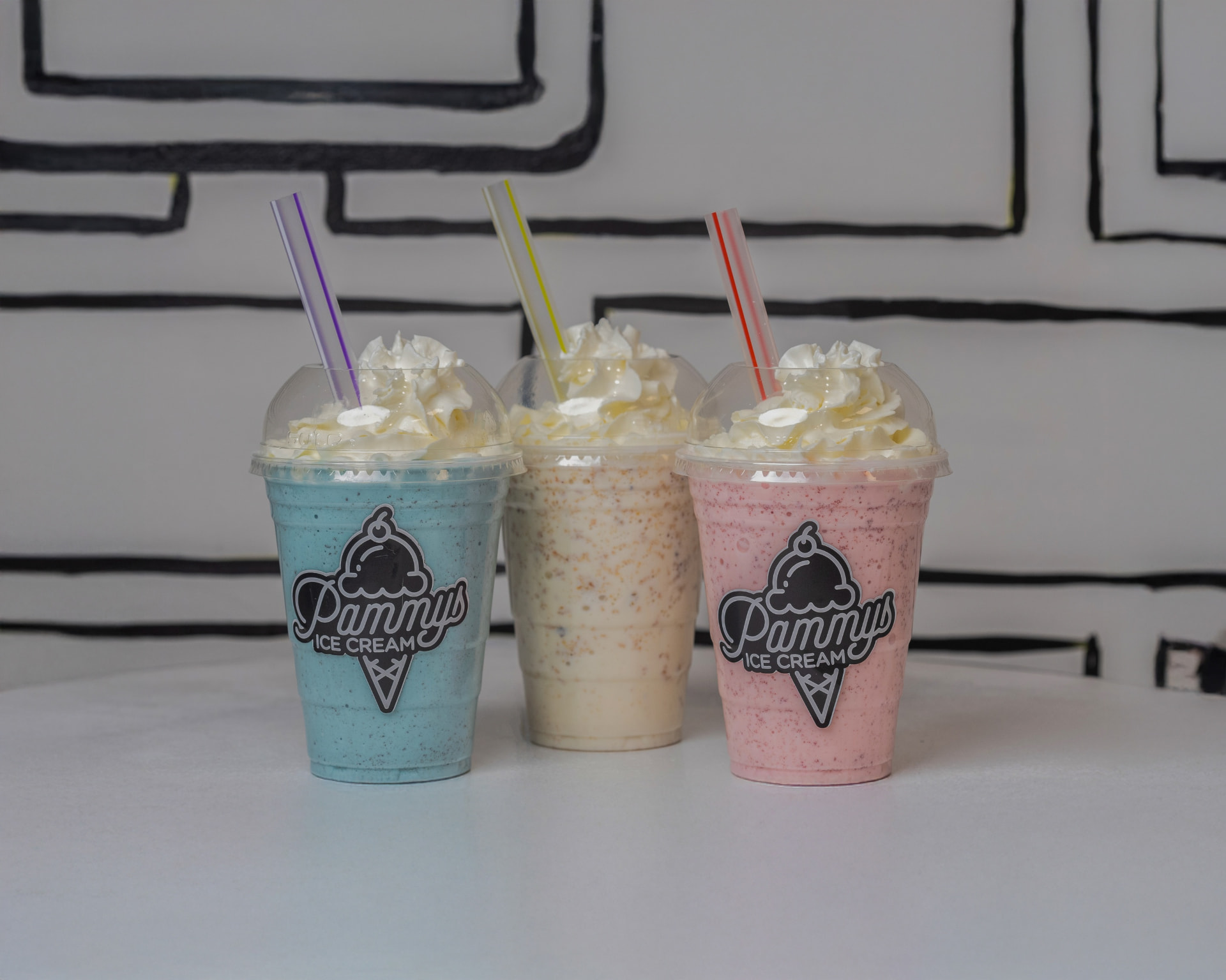 Three branded Pammy's milkshakes side by side