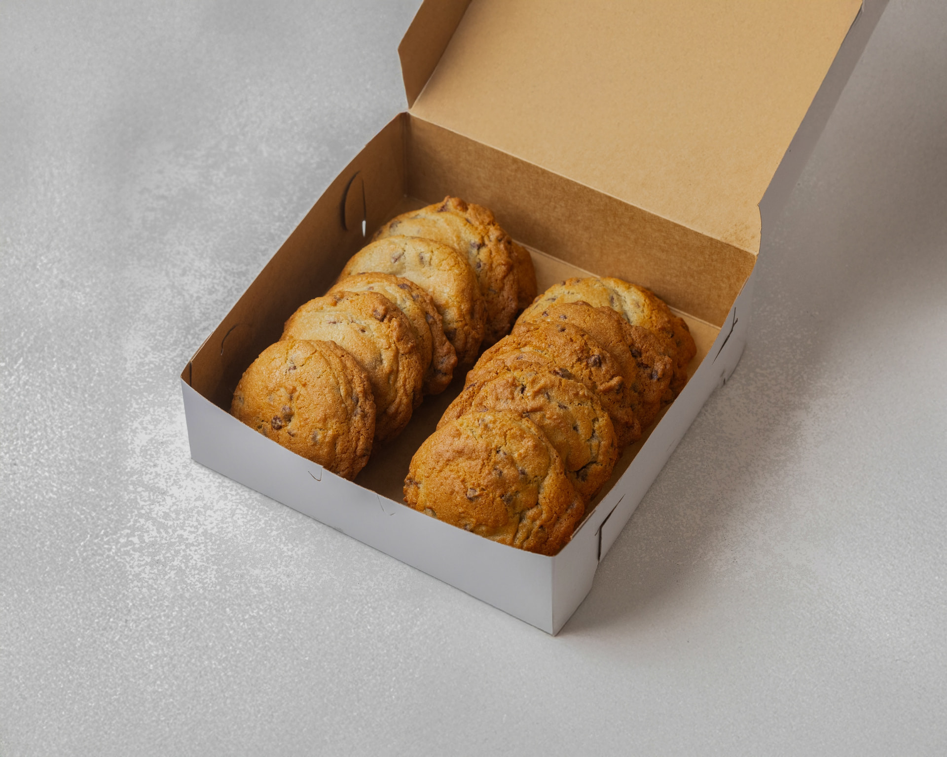 A dozen scratch-made chocolate chip cookies in a Pammy's box